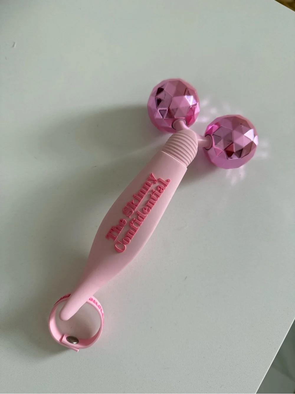 The Skinny Confidential pink balls facial massager